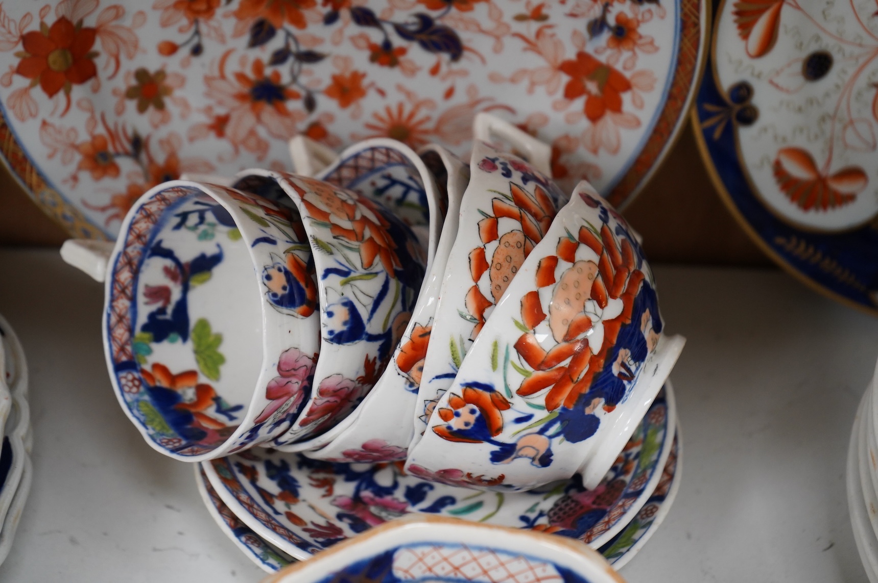 A collection of 19th century English ironstone china to include two pairs of sauce tureens, covers and stands, one marked Masons, various side plates and teacups